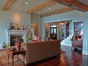 Exposed beams, ornate fireplace and custom iron stair rail